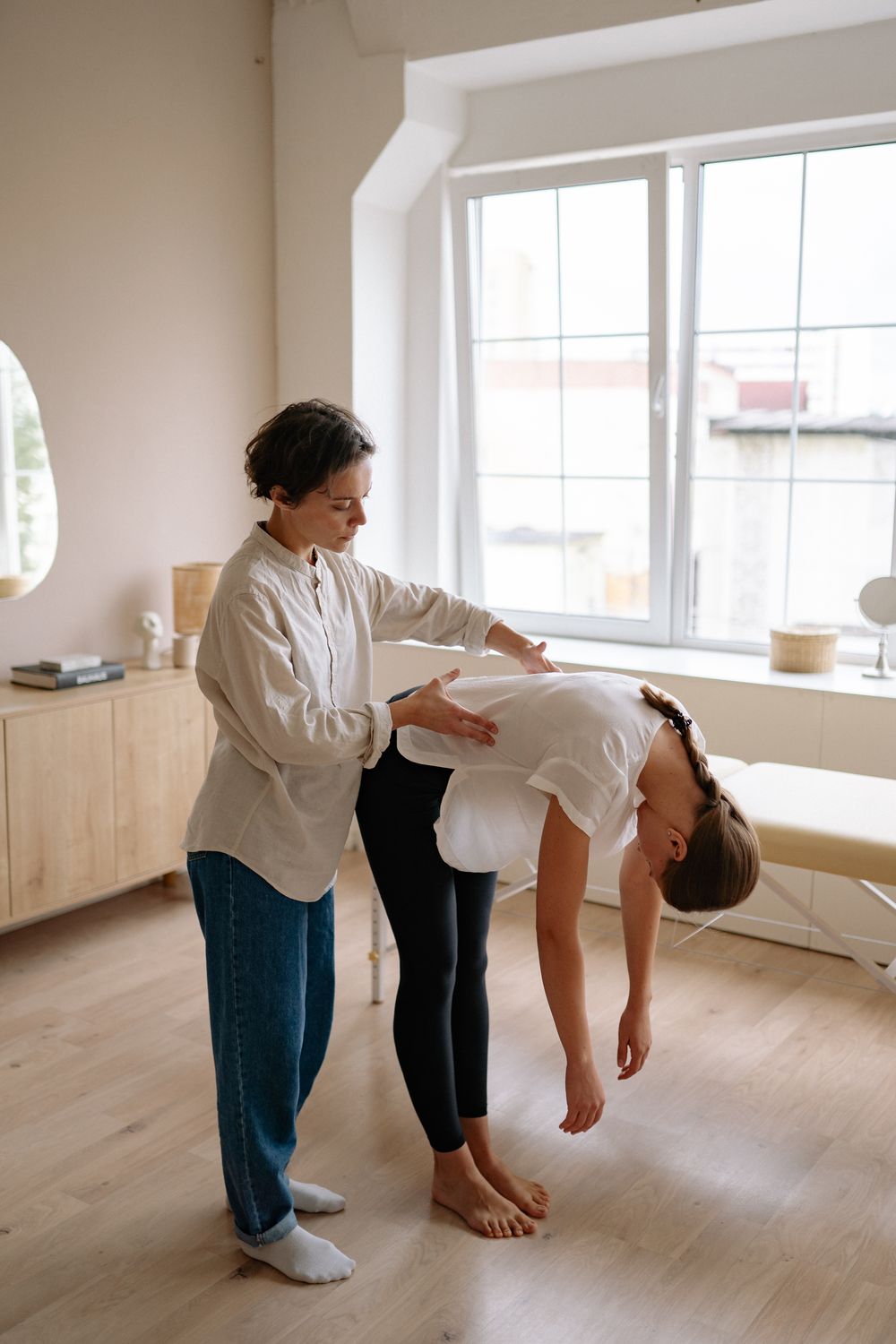 Therapist guiding a patient through movement