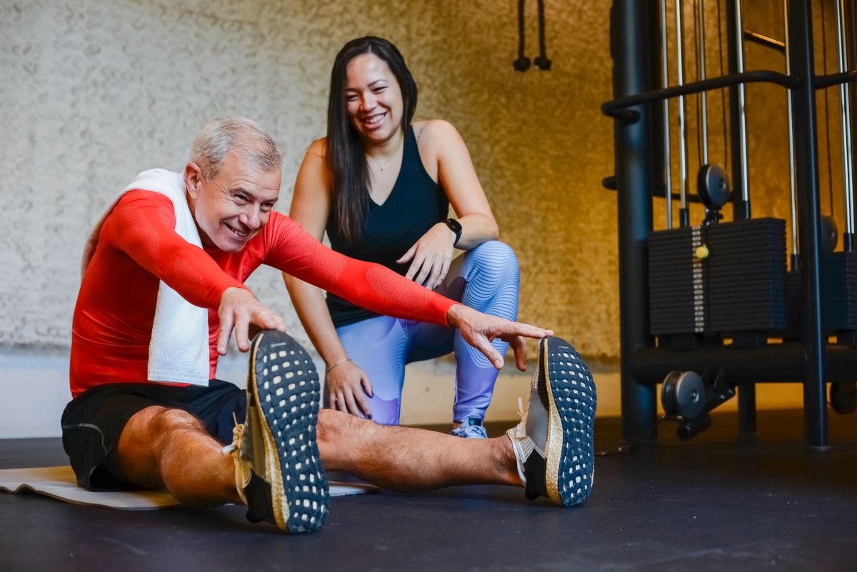 Physical therapist helping a patient stretch