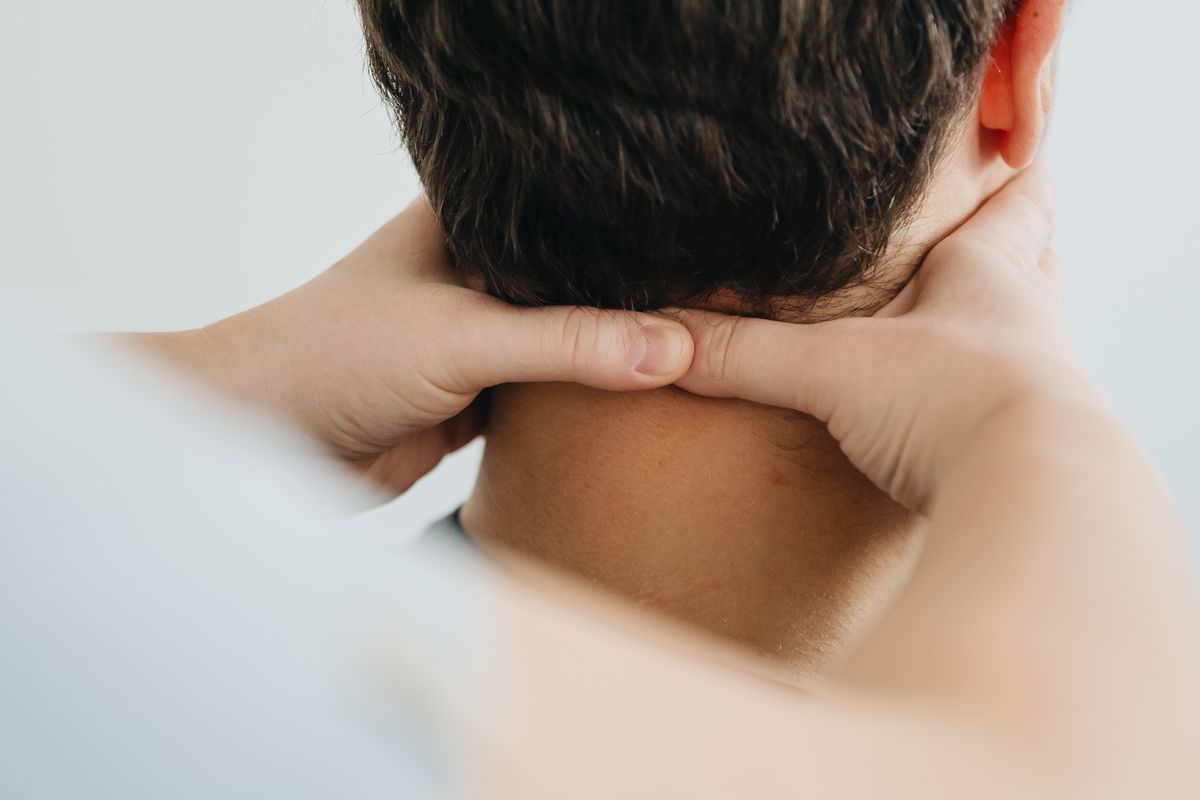 Therapist easing a patient's neck pain